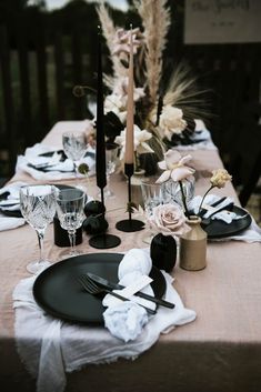 the table is set with black and white place settings