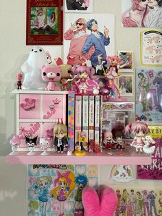 there is a shelf with many toys and dolls on it, including pink booties