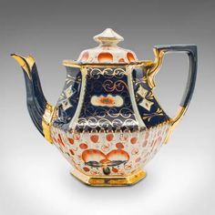 an ornately decorated teapot with gold trimming