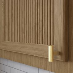 a close up of a wooden cabinet with white tile