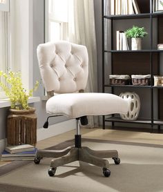 an office chair with wheels in front of a bookcase and bookshelf behind it