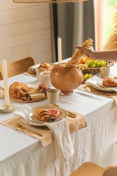 a table is set with food and candles