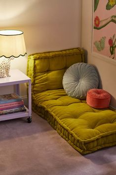 a living room with a futon bed next to a lamp