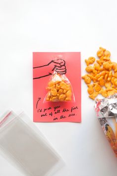 a bag of cheetos sitting on top of a table next to some candy