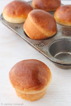 muffins sitting in a muffin tin on a table