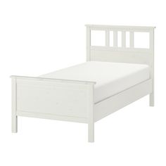 a white bed frame with no sheets on it