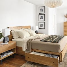 a bedroom with white walls and wooden furniture