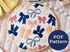 an embroidery pattern with bows and pearls