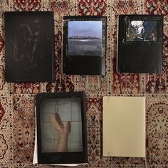 there are four pictures hanging on the wall next to each other with one hand in the middle