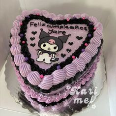 a heart shaped cake decorated with an image of a cat on it's side