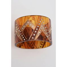 This is part of Chairish’s Fine Jewelry assortment.  This French wide cuff bracelet has inverted V's with gold applied and rhinestones adorning the v patterns.. It is amber colored tortoise resin. It has an Art Deco look but from the 80's. The interior of the cuff is 2.5 Inches. This is perfect for all wardrobes and all seasons. Great on the wrist and a great deco look. This will look fantastic for seasons of 2024 and resort wear. Tres chic! Tortoise Jewelry, 80s Jewelry, Wide Cuff Bracelets, Wide Cuff, Plastic Jewelry, Amber Color, Tres Chic, Best Wear, 10k Gold