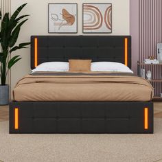 a bed with an illuminated headboard and foot board is in a room next to a potted plant