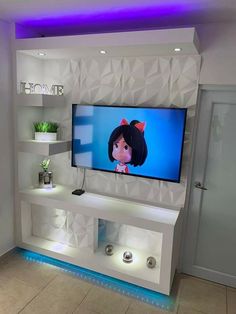 a flat screen tv sitting on top of a white shelf