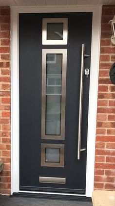 a modern steel door on a brick building