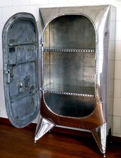 an old looking metal cabinet sitting on top of a hard wood floor