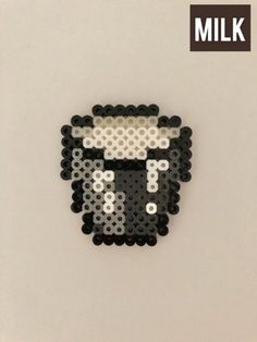 a black and white animal made out of legos with the word milk on it