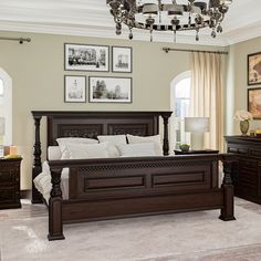 a bedroom with a bed, dressers and pictures hanging on the wall above it