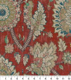 a red and blue floral pattern on fabric with a ruler in front of it,