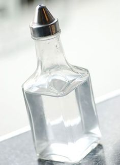 an empty glass bottle sitting on top of a counter