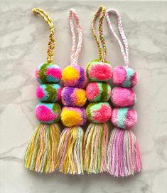 multicolored pom pom tasselled keychains on marble surface