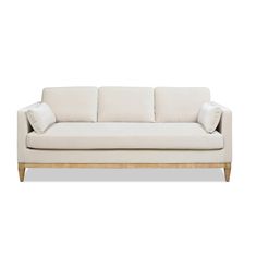 a white couch sitting on top of a wooden frame