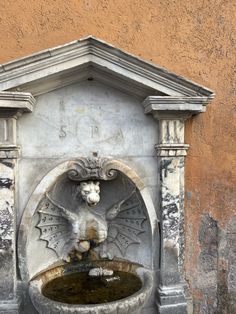 a fountain with a lion head on it