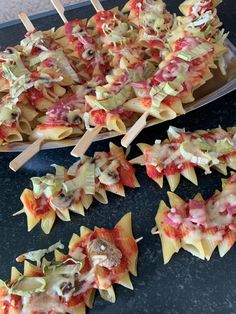 several appetizers with toothpicks in them on a table