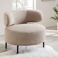 a round chair sitting on top of a white rug