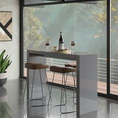 a table with two stools next to a window