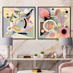 two abstract paintings on the wall in a living room with pink chairs and a coffee table