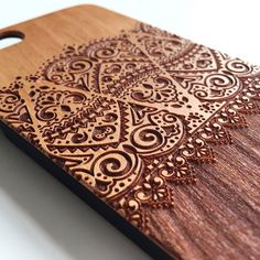 a wooden case with intricate designs on the front and back cover for an iphone 4g