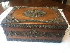 an ornate wooden box sitting on top of a table