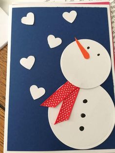 a card with a snowman made out of paper and some hearts on the side