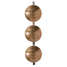 three metal balls on a pole against a white background