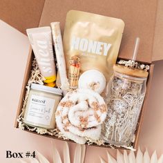 an open box containing various items such as soaps, toothpaste and honey