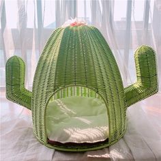 a large green cactus shaped chair sitting on top of a table