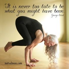 an older woman is doing yoga in front of a wall with a quote on it