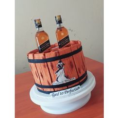 a cake made to look like two bottles of whiskey in a barrel