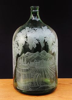 a glass bottle with a drawing on it