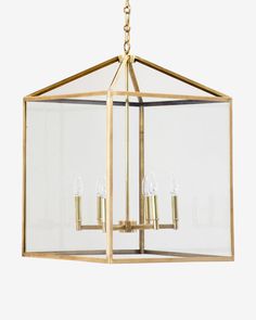 a gold chandelier with three lights hanging from the bottom and one light in the middle