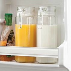 an open refrigerator with milk and orange juice in it