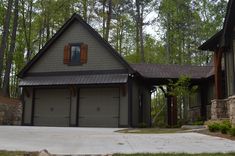 a house in the woods with two garages