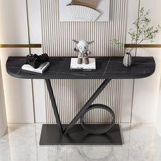 a black marble console table with two vases on it