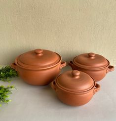 three brown pots sitting next to each other