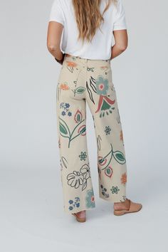 You'll love the unique and special print of the Toscana Printed Wide Leg Pants! You're going to want to rock these adorable pants with all your cute boho tops because they feature: Comfortable stretch denim fabric with so cute hand-drawn-inspired print throughout Flattering wide leg silhouette Classic high-rise waistline with a zipper-fly closure Convenient side and back patch pockets and belt loops Pair with: Tricks Up Her Sleeve Sweater, Mulholland Draped Cardigan, and Kapalua Bay Adjustable T Spring Hippie Wide Leg Bottoms, Hippie Wide Leg Bottoms For Spring, Trendy Cotton Bottoms With Graphic Print, Trendy Graphic Print Cotton Bottoms, Casual Printed Straight Leg Bottoms, Bohemian Cotton Wide Leg Pants With Relaxed Fit, Casual Cotton Printed Bottoms, Hippie Wide Leg Bottoms With Loosely Fitted Hips, Casual Printed Cotton Bottoms