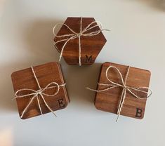 three wooden coasters tied with twine and monogrammed ribbon on top of each other