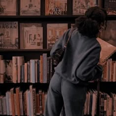 a person standing in front of a book shelf