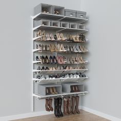 a white shoe rack with many pairs of shoes hanging on the top and bottom shelves