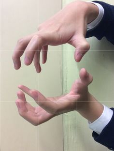 two hands reaching out towards each other in front of a mirror with their fingers extended