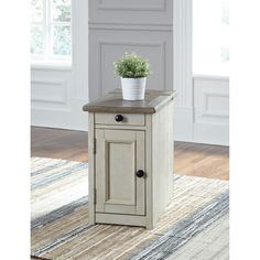 an end table with a potted plant on top